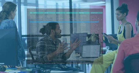 Developers collaborating in modern open office with gesturing lead and code overlay