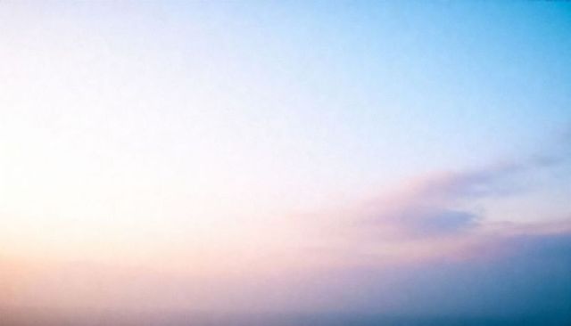 Pastel sunrise gradient sky showing thin cirrus clouds and haze for minimalist background