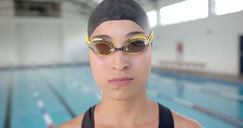 Female Swimmer Prepares for Training at Indoor Pool