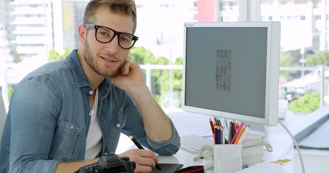 Young Professional Designer Smiling in Front of Computer in Modern Office - Download Free Stock Images Pikwizard.com