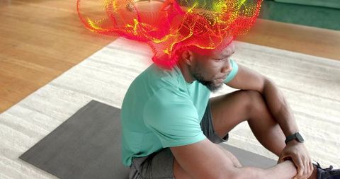 Athlete resting on exercise mat wearing smartwatch with red-orange energy wave overhead