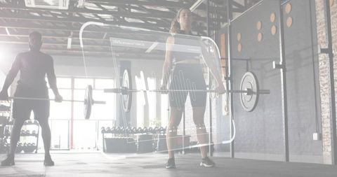 Female athlete lifting loaded barbell with HUD fitness overlay in industrial gym training