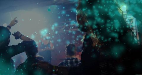 Silhouetted crowd watching live concert with teal haze lighting and moody club atmosphere
