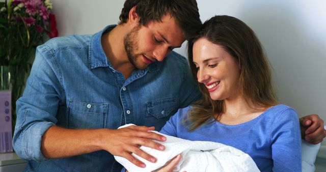 Happy Parents Gently Holding Newborn Baby at Home - Download Free Stock Images Pikwizard.com