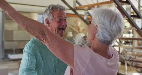 Joyful Senior Couple Embracing at Home