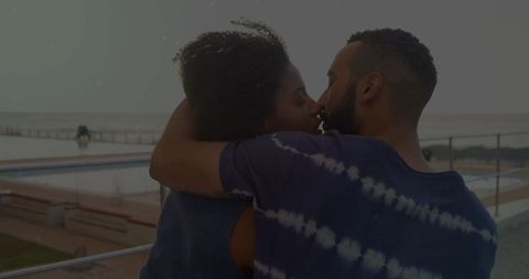 Romantic Couple Embracing Seaside Walkway