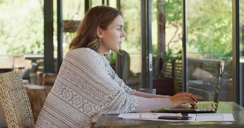 Pregnant Woman Working from Home on Laptop in Natural Setting