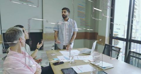 Business Meeting with Printed Charts in Modern Office Space