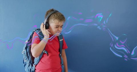 Young Schoolboy Immersed in Digital World with Headphones