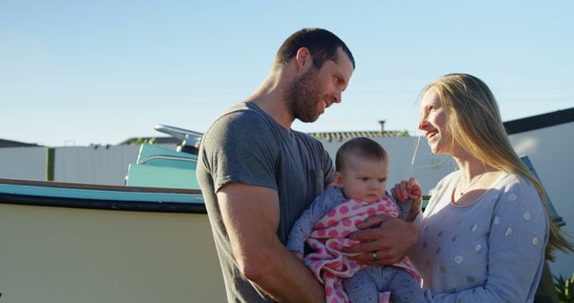 Young Family Smiling Outdoors with Baby under Blue Sky - Download Free Stock Images Pikwizard.com