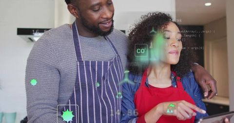 Couple exploring augmented reality recipe app while cooking together in modern kitchen