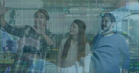 Professionals analyzing data charts on transparent screen in modern office