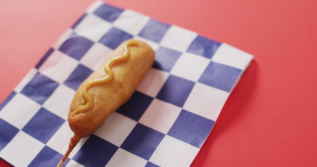 Image of corn dog with mustard on a red surface - Download Free Stock Photos Pikwizard.com