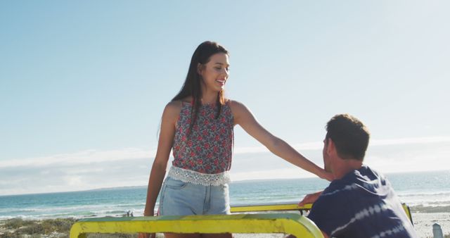 Caucasian couple sitting in beach buggy by the sea talking and dancing. beach stop off on summer holiday road trip.