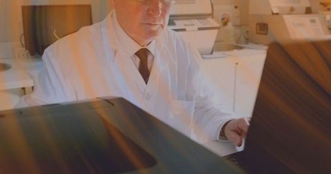 Scientist using laptop in modern laboratory setting