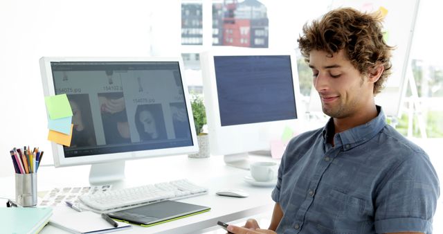 Young professional using smartphone in bright modern office - Download Free Stock Images Pikwizard.com