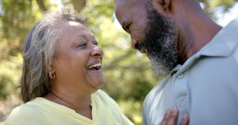 Joyful Senior Couple Bonding in Nature on a Sunny Day