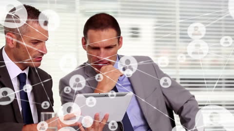 Business Professionals Analyzing Network Data on Tablet
