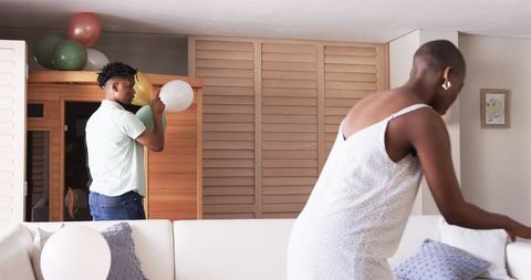 Friends Preparing for Party with Festive Balloon Decorations