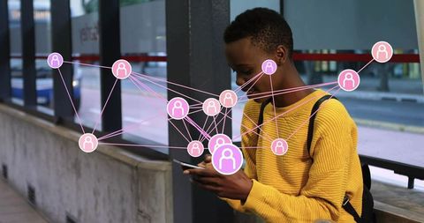 Commuter tapping smartphone at transit shelter connecting to social network and mobile messages