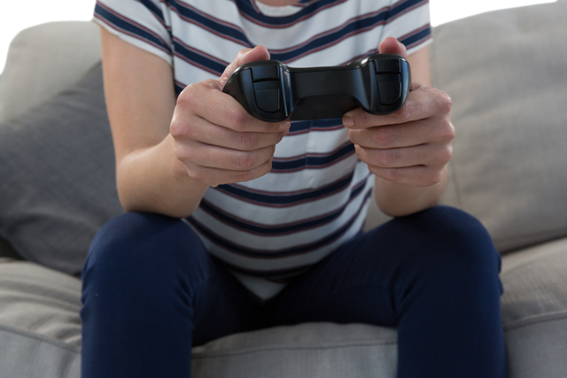 Transparent Woman's Hands Holding Video Game Controller on Cushion Sofa - Download Free Stock Videos Pikwizard.com