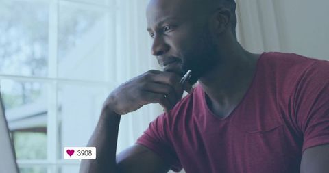 Thoughtful Adult Man Holding Pen Near Window Gaining Social Media Likes