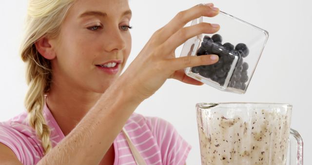 Young Woman Making Healthy Smoothie with Blueberries - Download Free Stock Images Pikwizard.com