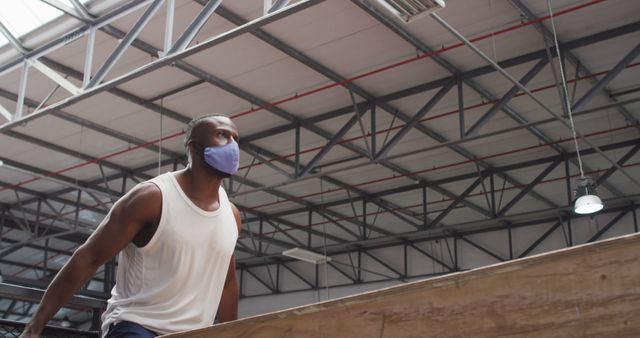 Athlete Wearing Face Mask Practicing Parkour in Industrial Gym - Download Free Stock Images Pikwizard.com