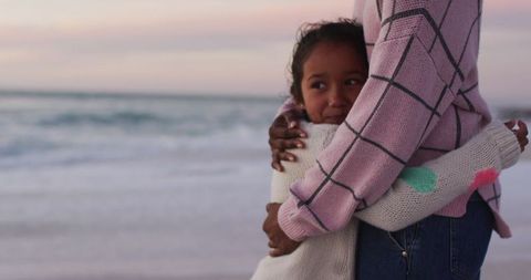 Mother Daughter Embrace on Beach at Sunset