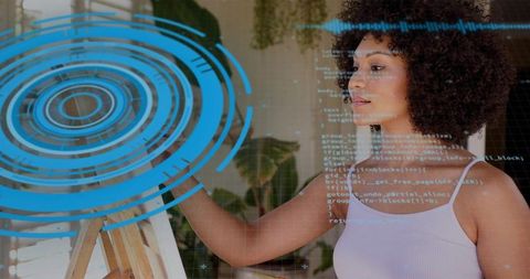 Woman painting and touching canvas with futuristic blue hud overlay in sunlit home studio