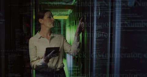 It technician diagnosing server rack with tablet in green-lit datacenter with code overlay