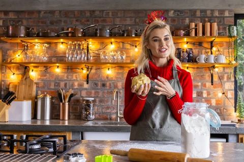 Baking festive christmas dough in cozy kitchen with string lights and copper accents