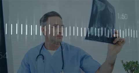 Mature Doctor Examining X-Ray Film with Stethoscope in Clinic Radiology and Diagnostics