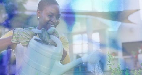 Woman nurturing plants in sunroom blissfully watering