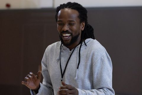 Motivational coach energizing with smiles and gestures