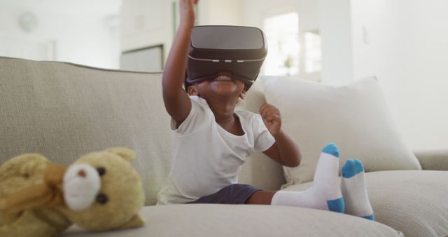 Excited child experiencing virtual reality at home - Download Free Stock Images Pikwizard.com