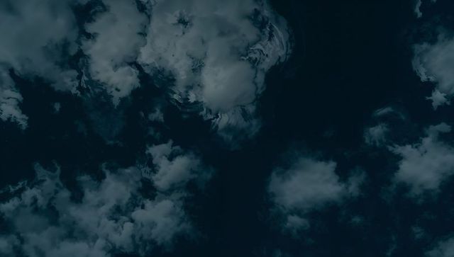 Moody satellite cloudscape over midnight sky dramatic storm texture