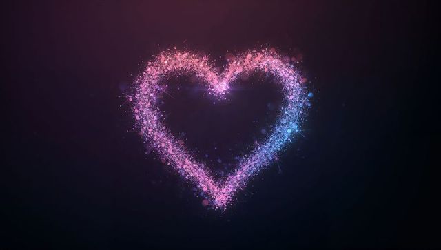 Glowing heart composed of pink and blue sparkling particles floating on dark gradient