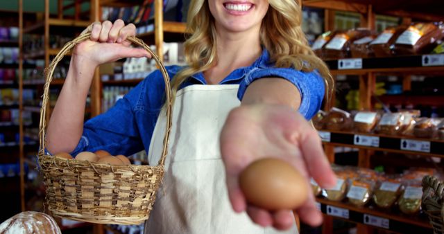Woman is in a grocery store, showcasing a fresh egg in one hand and holding a basket of eggs with the other. It can be used for emphasizing fresh, organic produce, healthy eating habits, local farming, and grocery shopping themes.