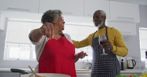 Senior Couple Enjoying Cooking Together in Kitchen
