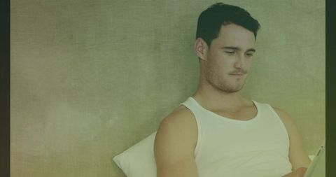 Young Man Relaxing Using Tablet at Home in Casual Environment