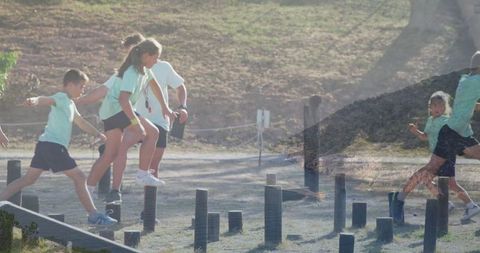 Children navigating outdoor obstacle course at camp