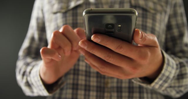 Person Texting on Smartphone While Wearing Plaid Shirt - Download Free Stock Images Pikwizard.com