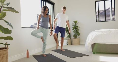 Diverse Friends Practicing Yoga Tree Pose in Bright Room