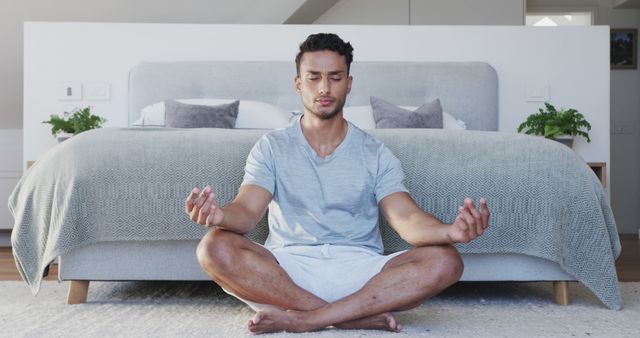 Man Practicing Meditative Yoga in Modern Bedroom - Download Free Stock Images Pikwizard.com