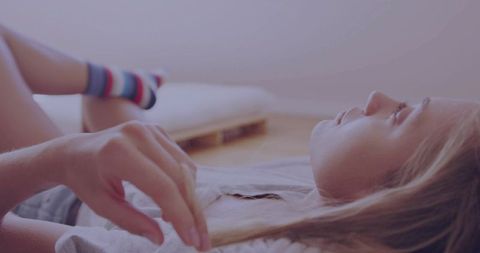 Relaxed Young Woman Lying on Minimalist Wooden Floor Setting