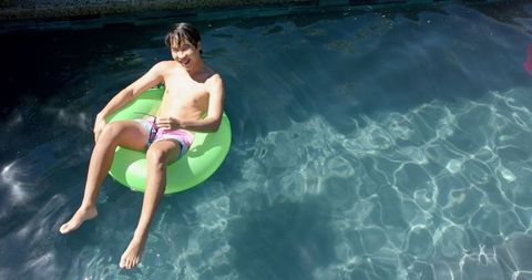 College Student Relaxing on Green Float in Swimming Pool - Download Free Stock Images Pikwizard.com