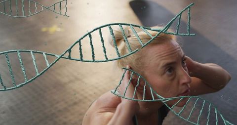 Woman performing crunches with floating dna helix overlays representing fitness and genetics