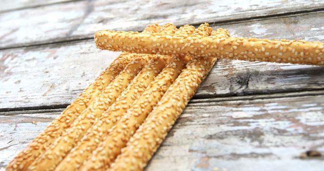 Crispy Sesame Breadsticks on Rustic Wooden Surface - Download Free Stock Images Pikwizard.com