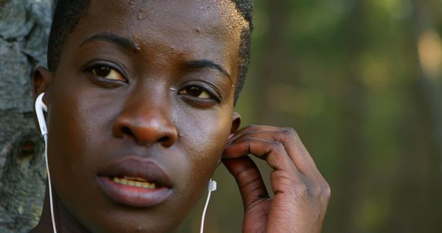 Person Listening to Music with Earbuds Outdoors in Nature - Download Free Stock Images Pikwizard.com